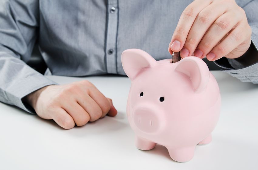 man putting coin in piggy bank. saving money concept